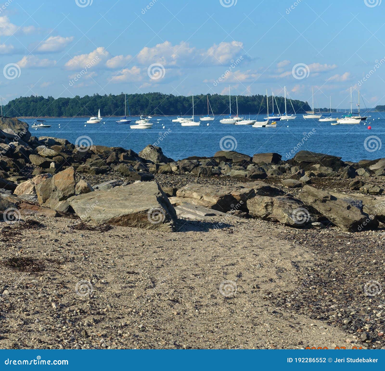 line of boats in water, line of rocks, line of trees, line of clouds
