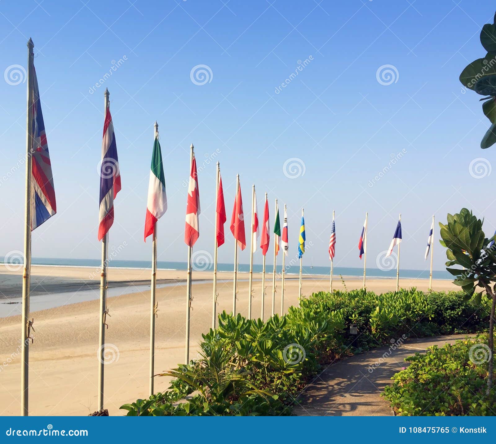 Sandy Beach and Flags of the Different Countries on the Seashore