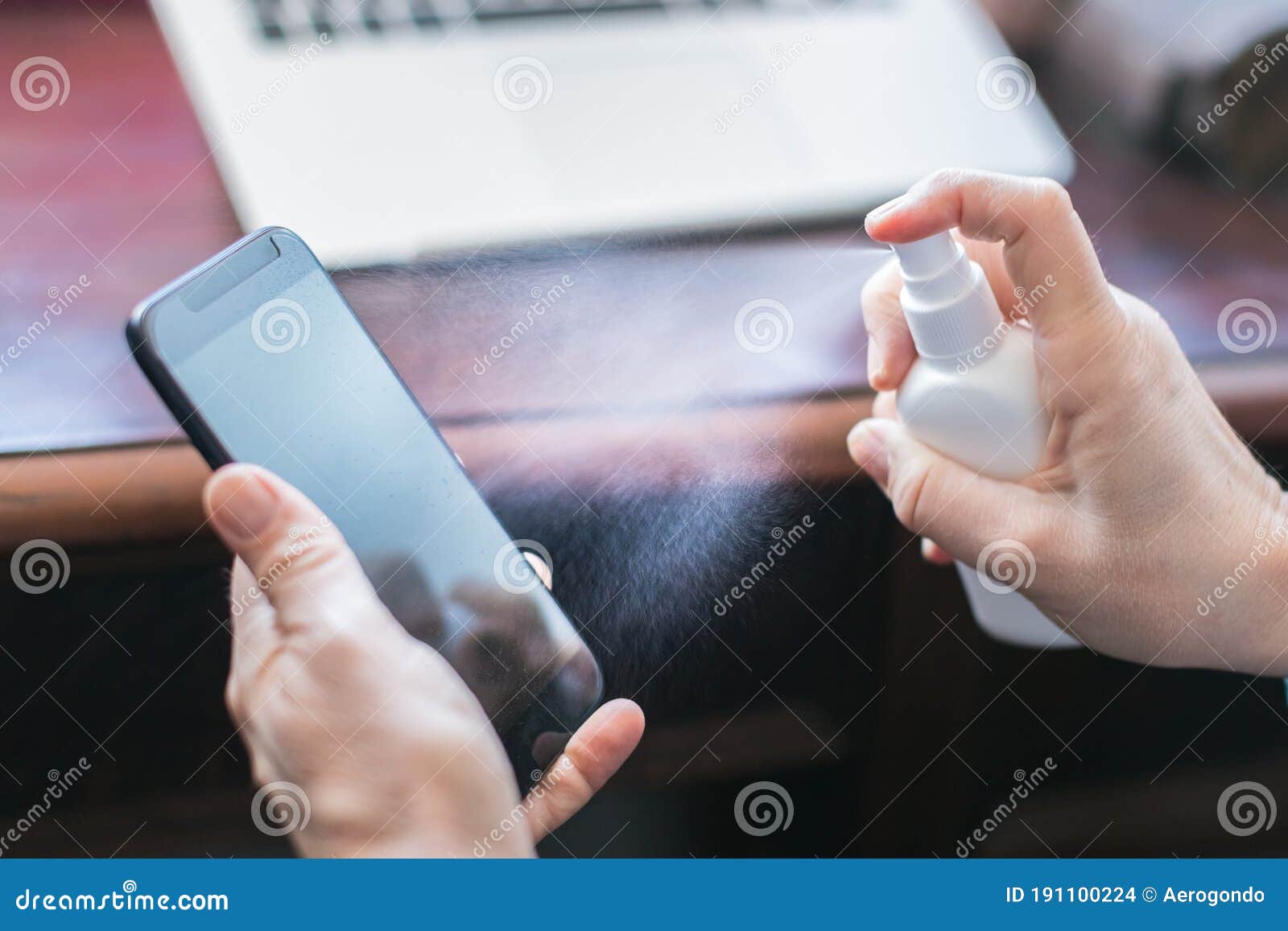 Sanitizing Mobile Phone with Alcohol Stock Photo Image of alcohol