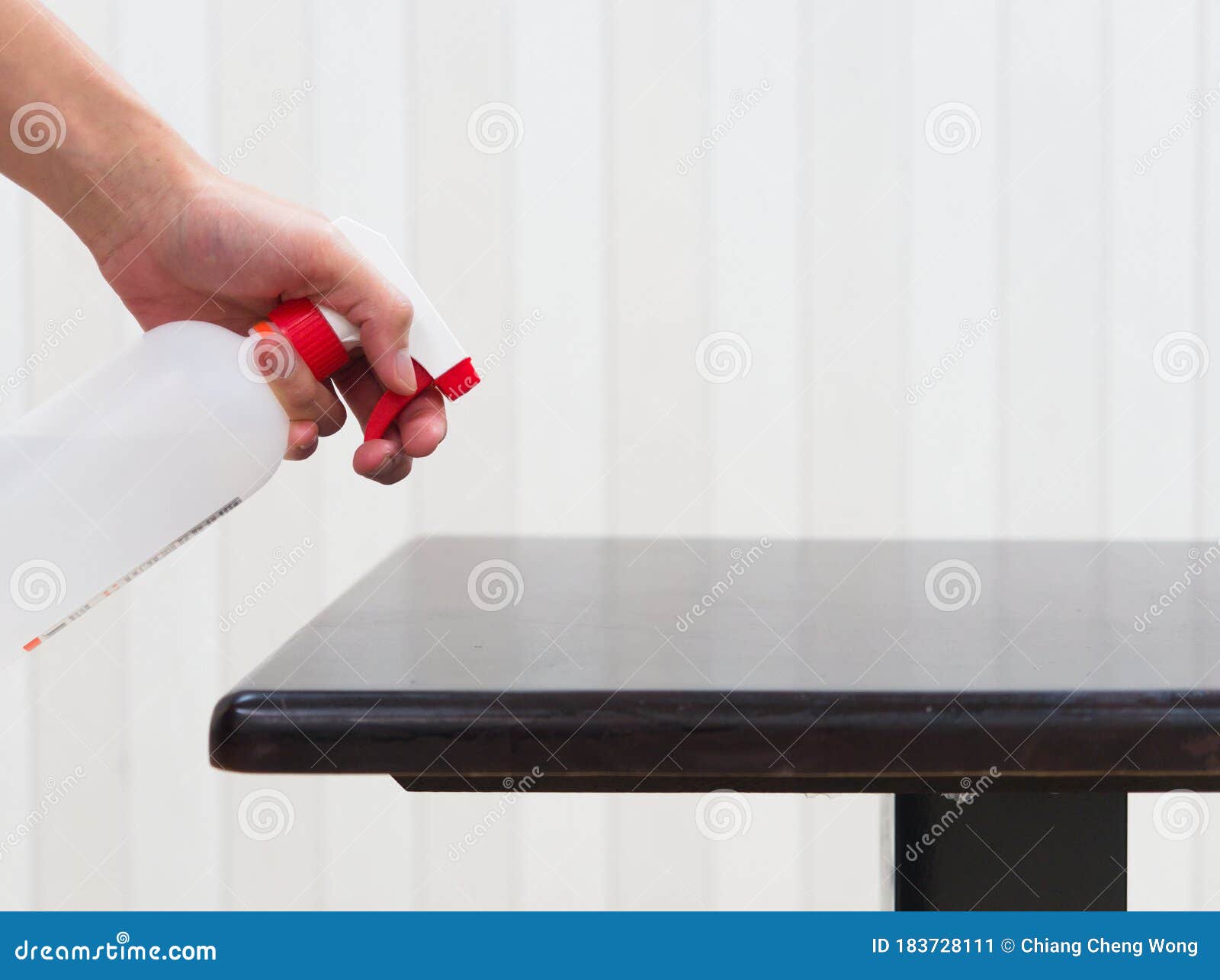 Sanitizing Table with Alcohol Disinfectant Spray Bottle in Restaurant