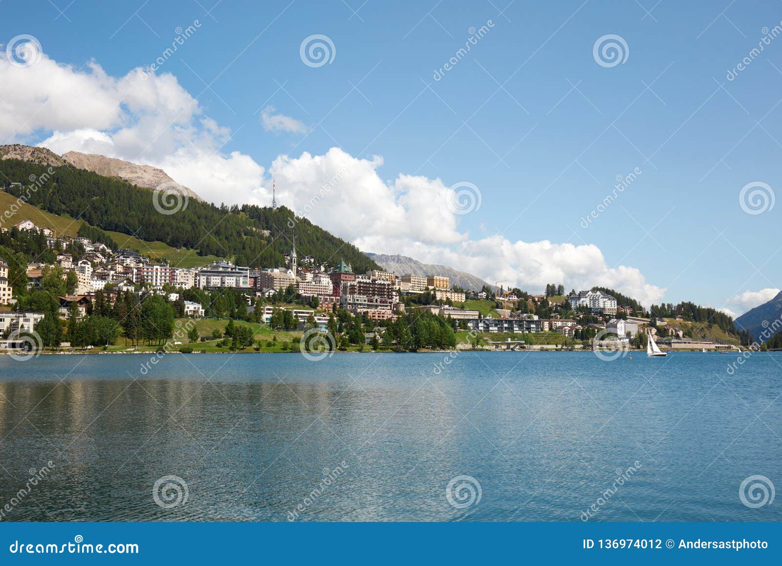 sankt moritz town, lake and sail boat in a sunny summer day in switzerland