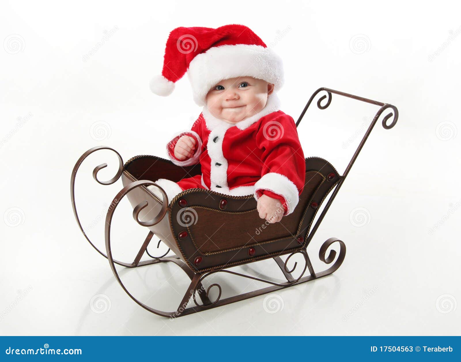 santa baby sitting in a sleigh