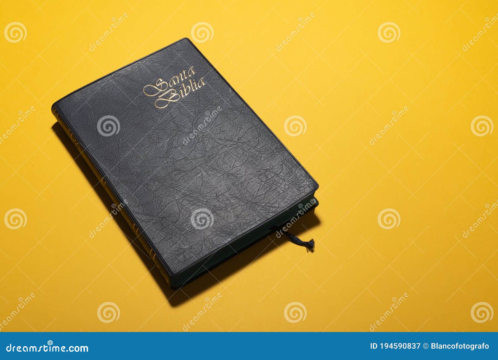 santa biblia holy bible in spanish over mustard yellow desk