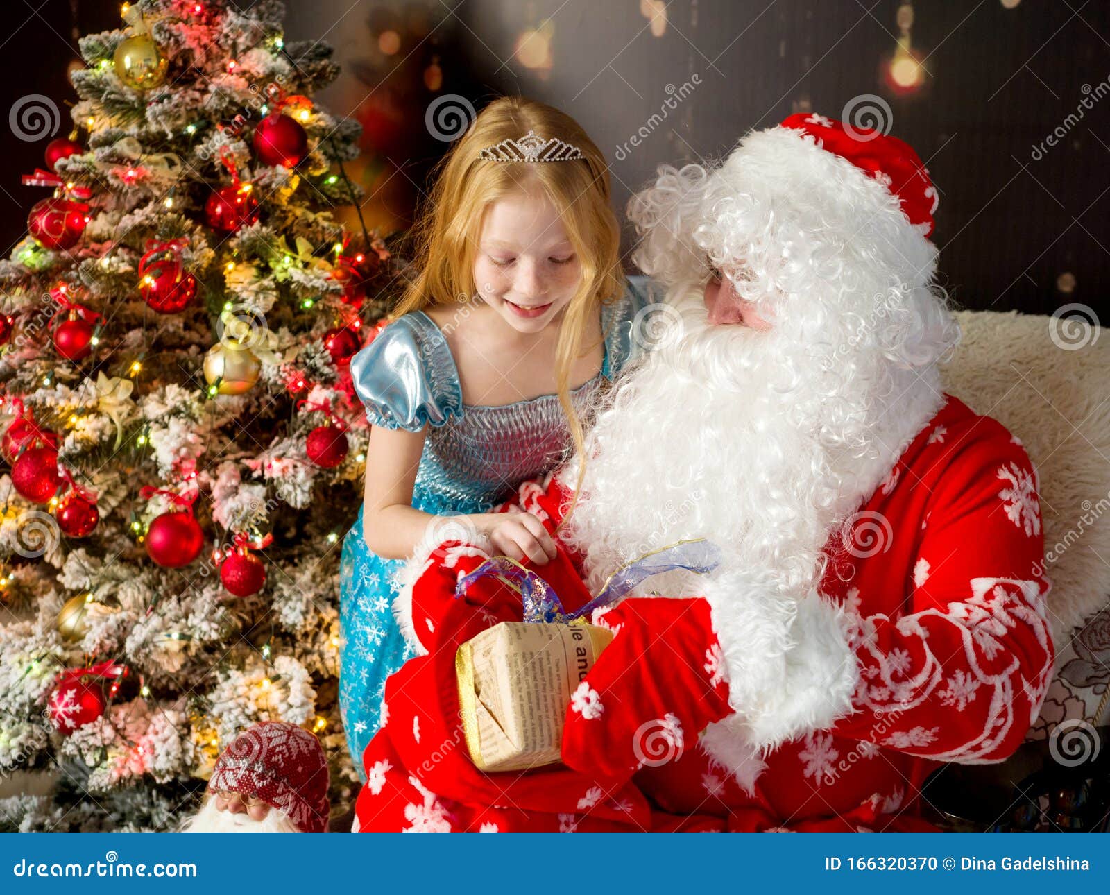 Santa Claus And Beautiful Girl With New Year Gifts At The