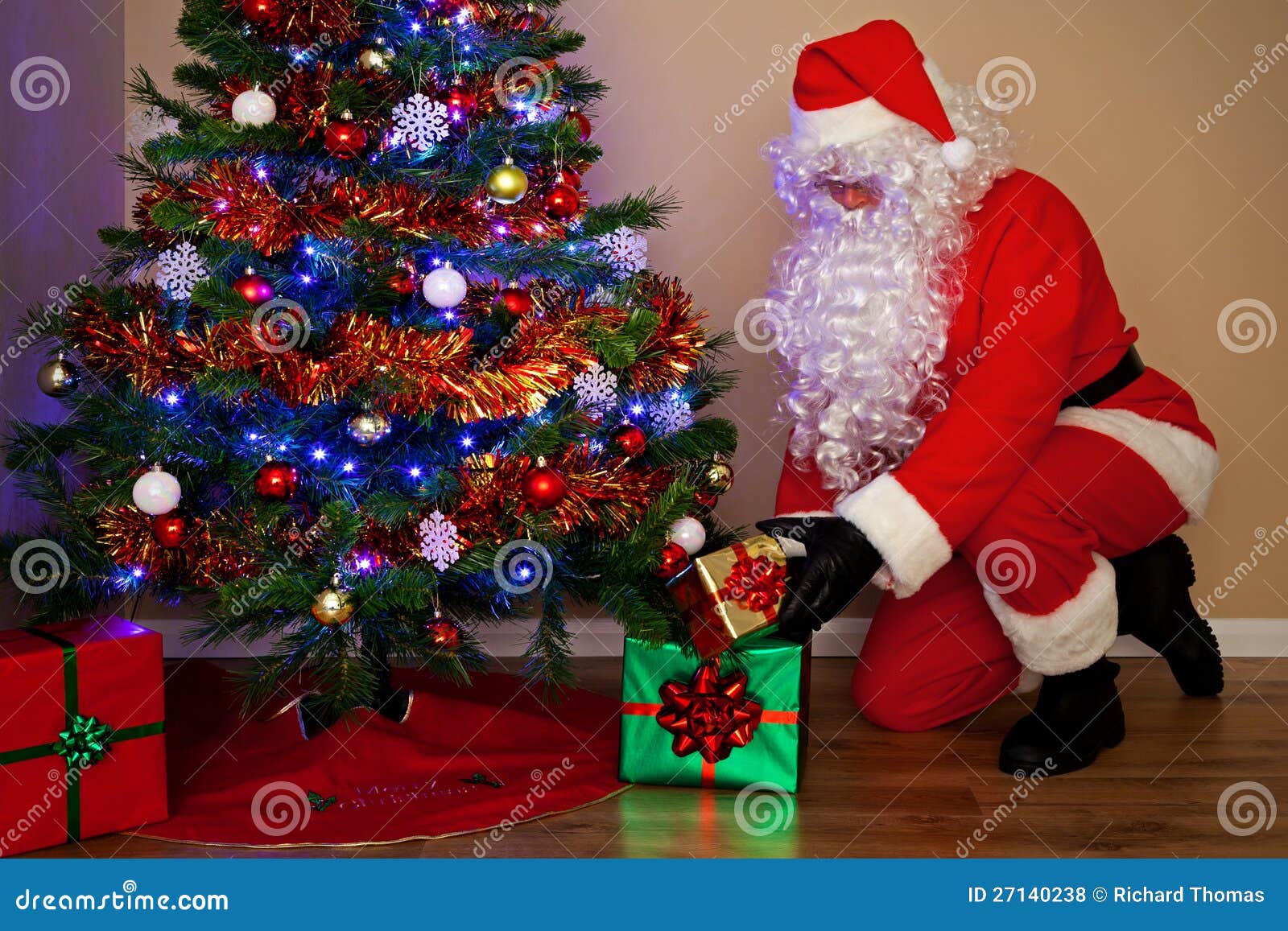 santa claus delivering presents under the tree.