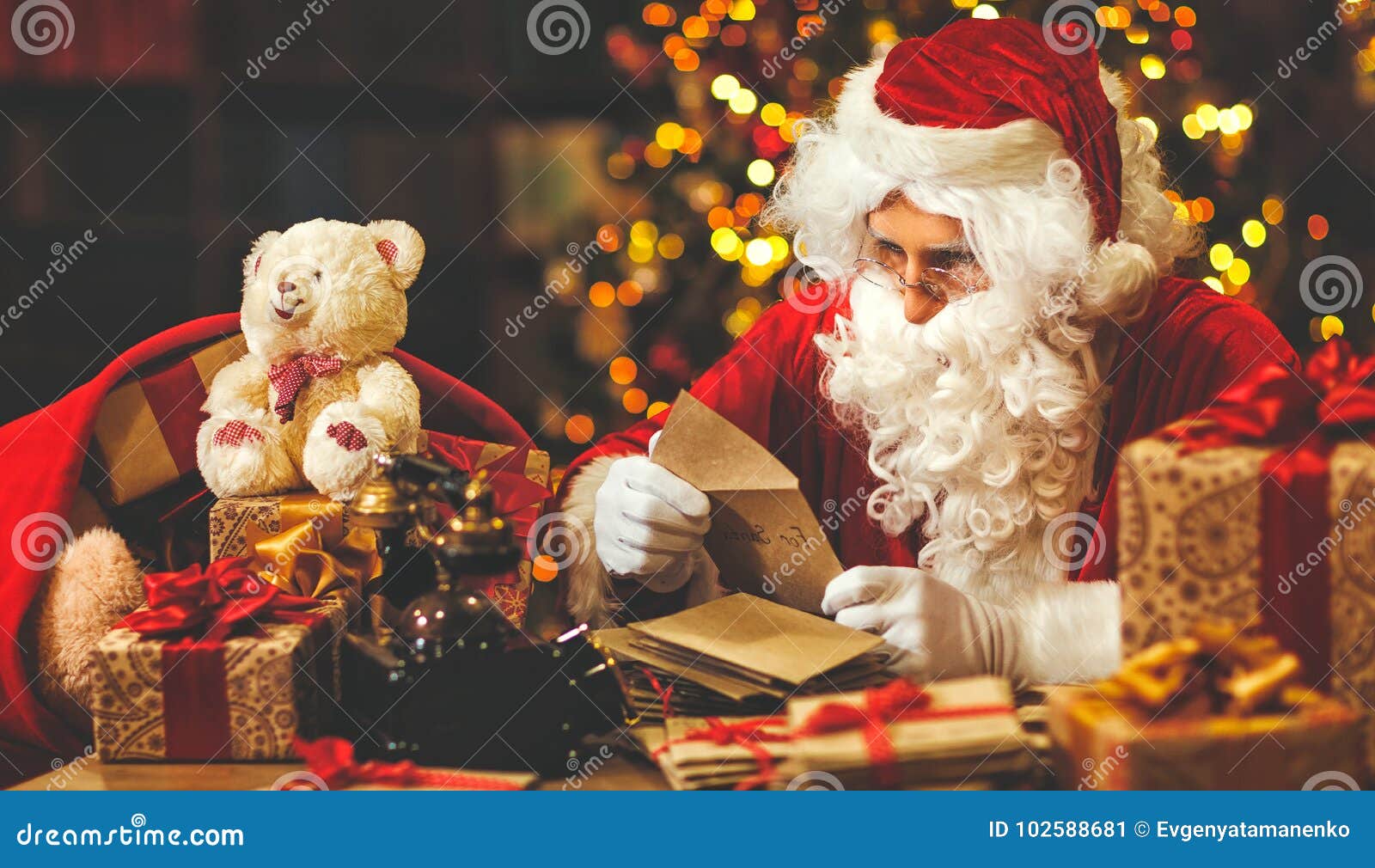 Santa Claus at Desk with Letters and Christmas Presents Stock Image ...