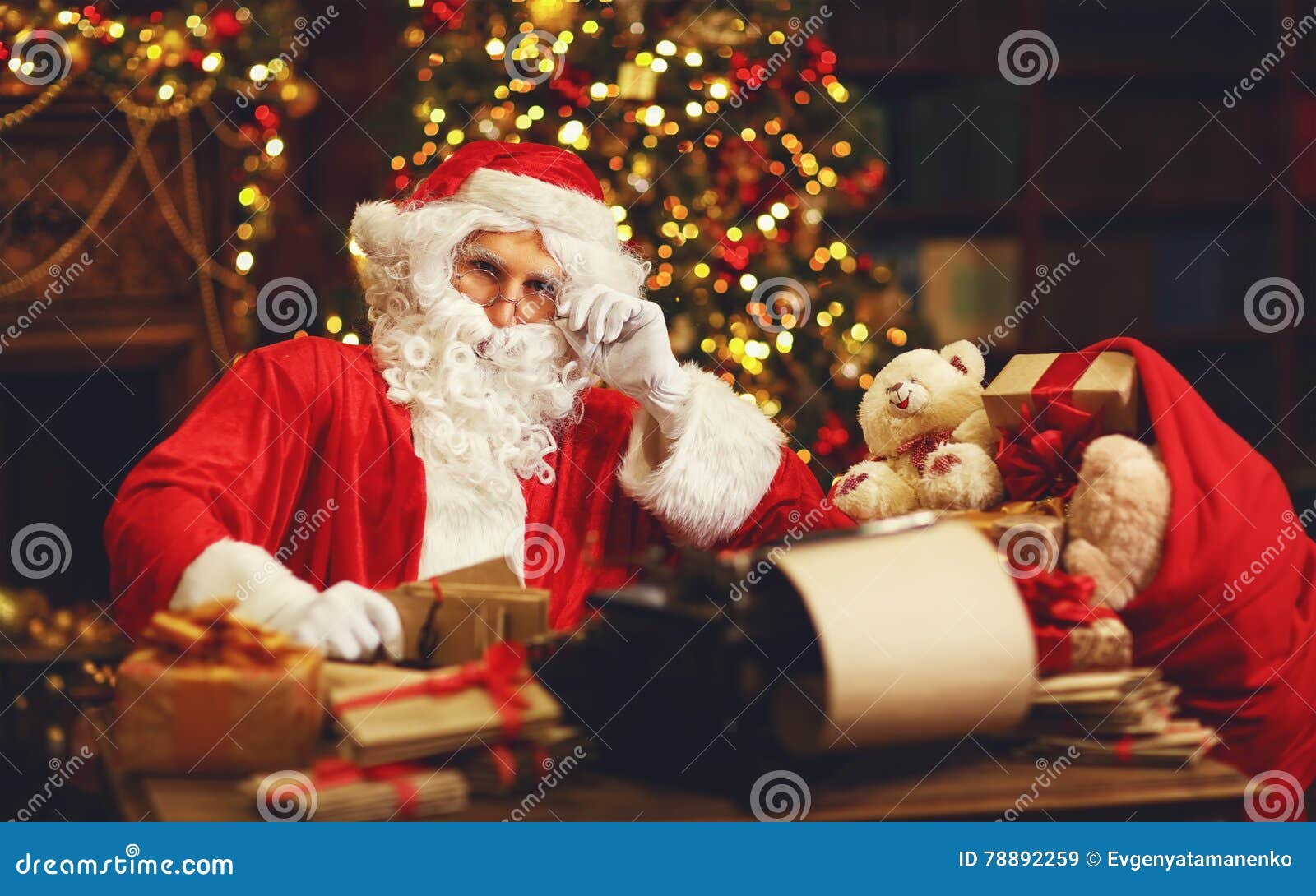 Santa Claus at Desk with Letters, Gifts Near Christmas Tree Stock Image ...