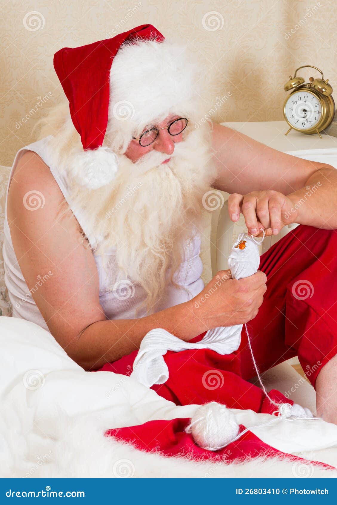santa claus mending his socks