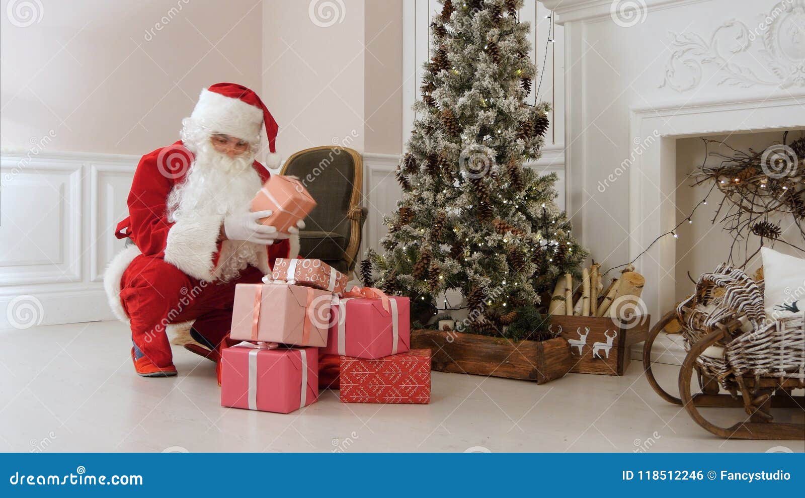 santa claus secretly putting gift boxes under the christmas tree