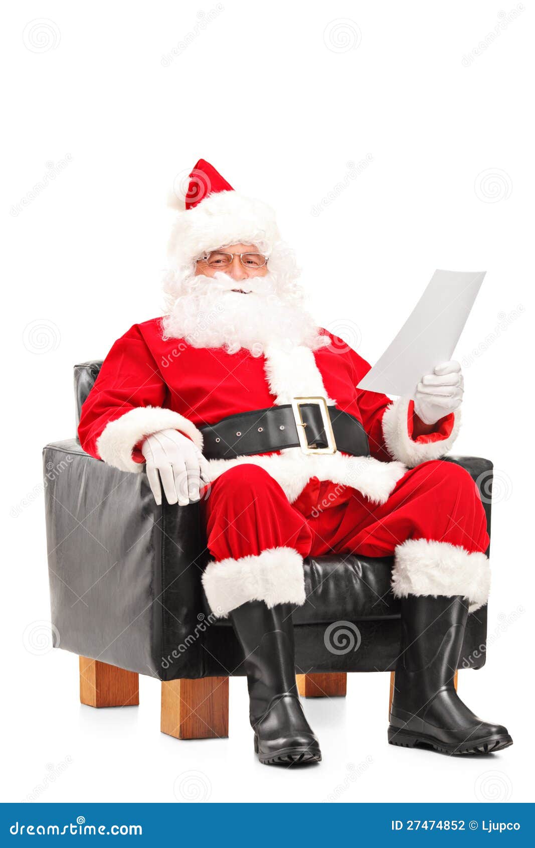 Santa Claus Sitting In Armchair And Reading Letter Stock 