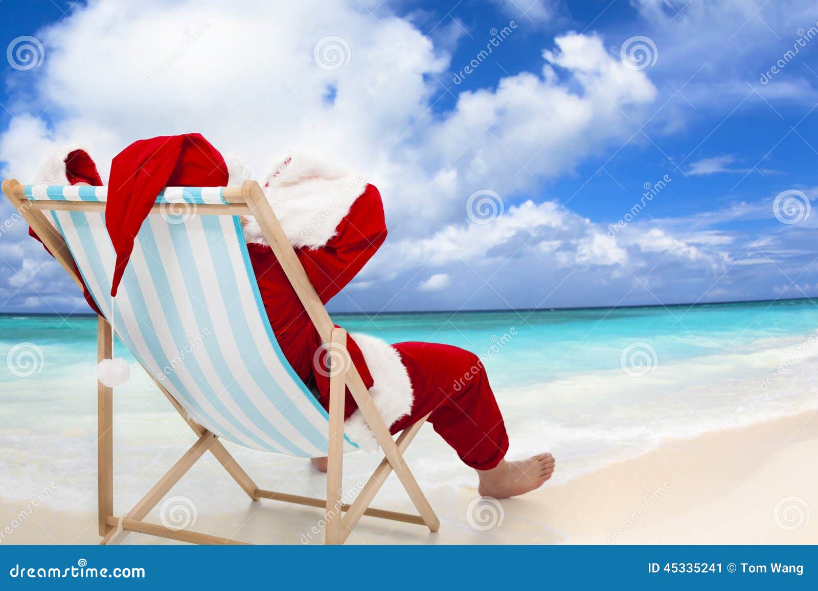 santa claus sitting on beach chairs. christmas holiday concept.