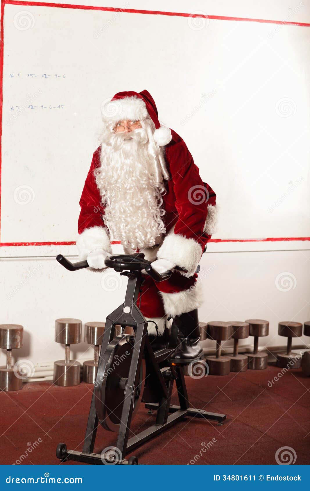 Santa Claus Training On Exercise Bike At The Gym Stock Image - Image