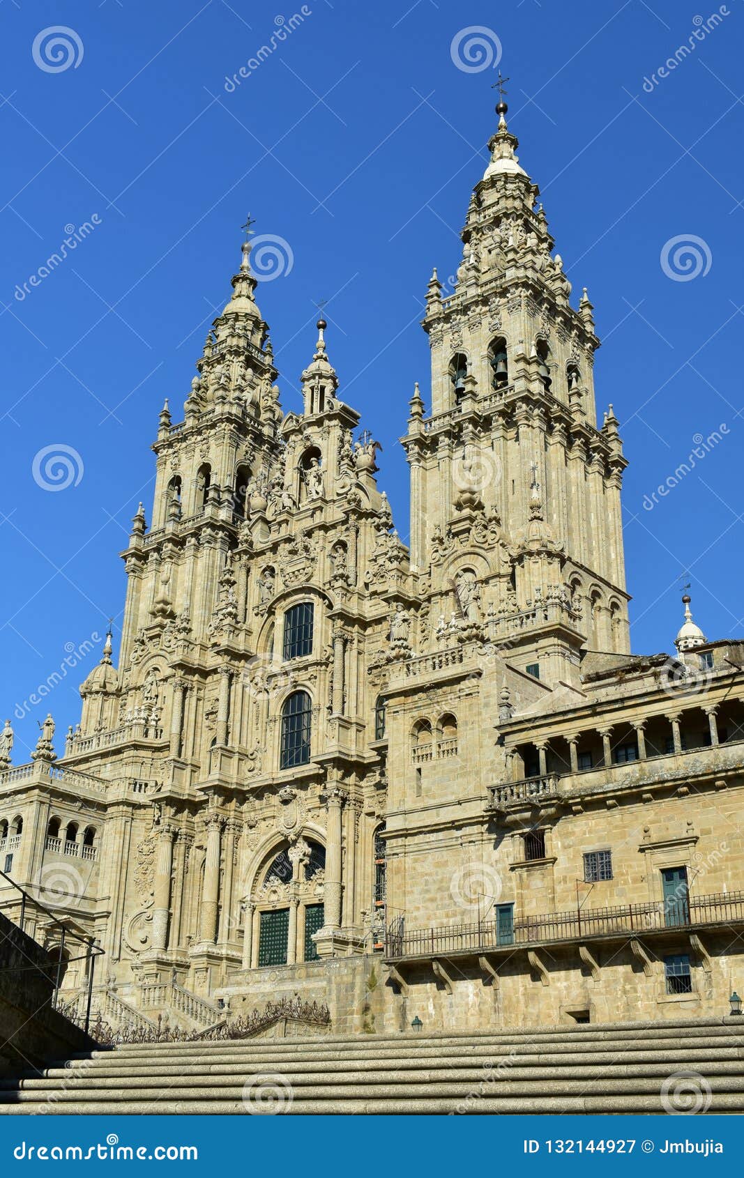 cathedral: side view from stairs. santiago de compostela, obradoiro square. spain. sunny day, clean stone, blue sky.