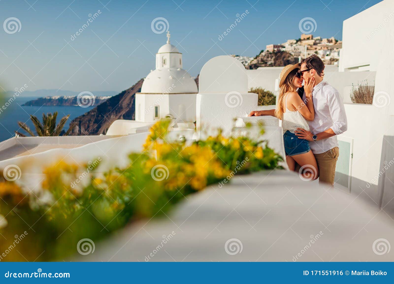 Santorini, Greece Honeymoon. Couple in Love Walking and Kissing in Fira