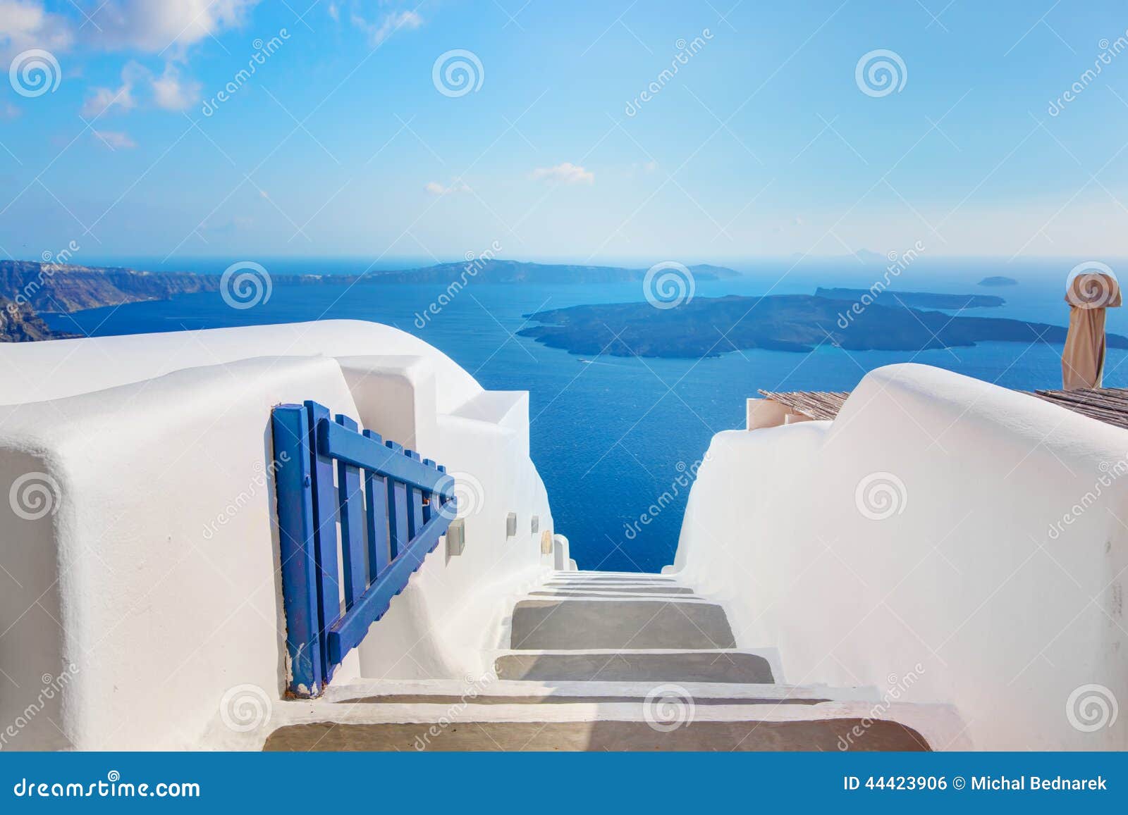 santorini, greece. open blue door with aegean sea view and caldera.