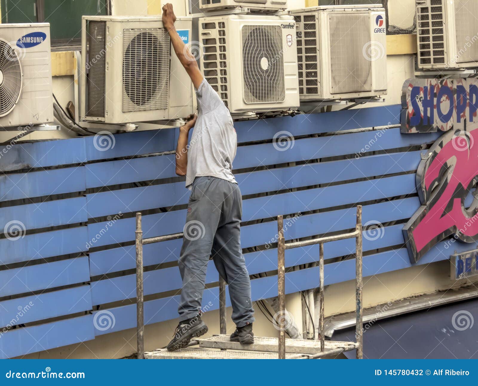 Worker Maintains An Air Conditioner On The Facade Of A Store In Downtown Sao Paulo Editorial Photography Image Of Electrician Maintain 145780432