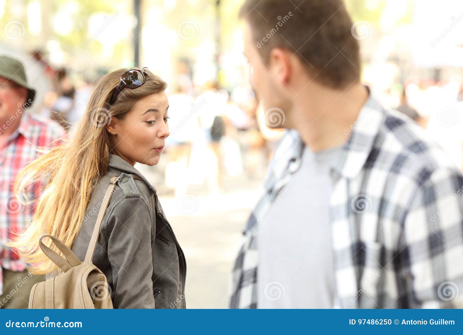 sassy girl looking at man bottom on the street