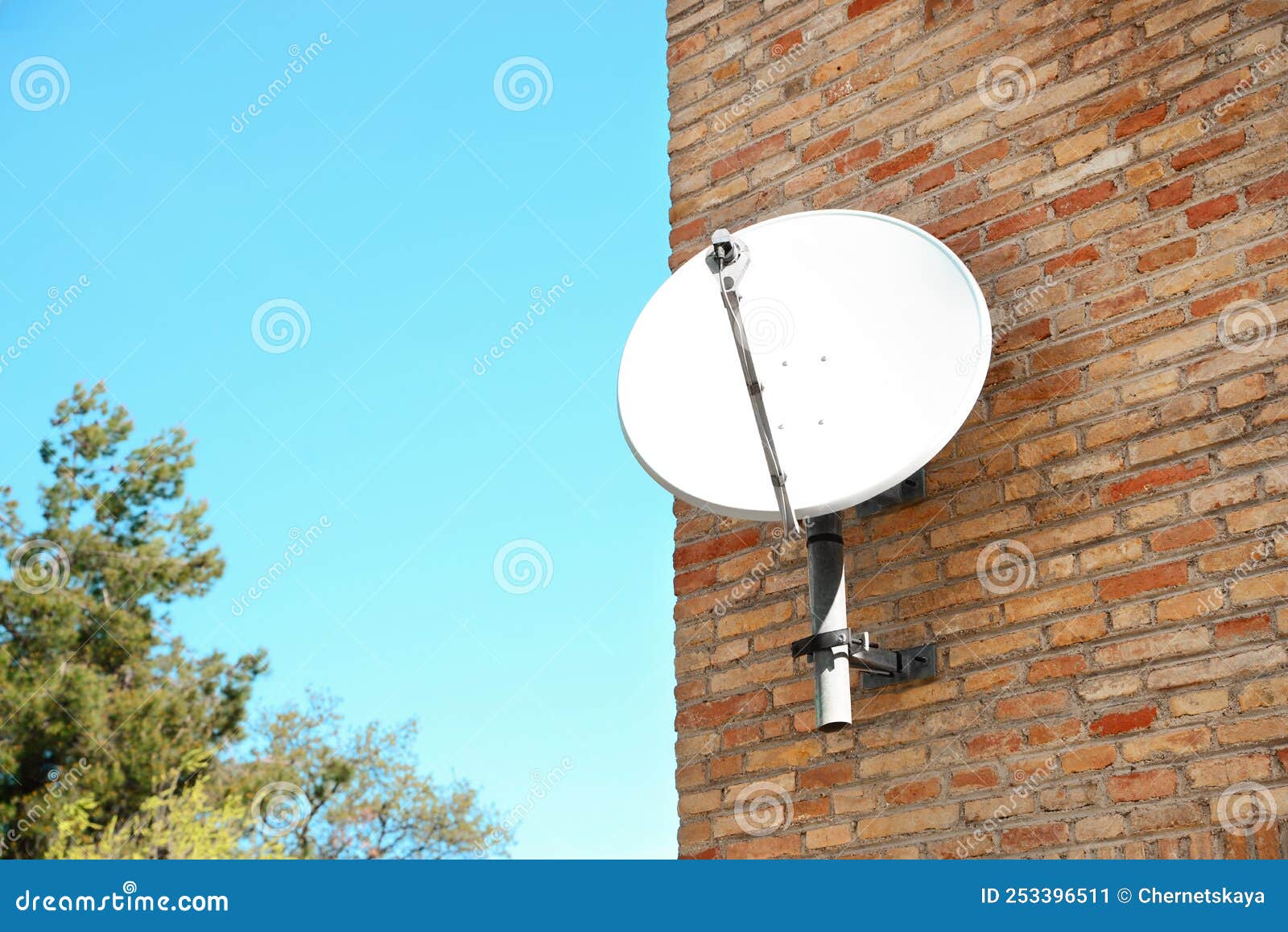Satellite Dish on Brick Wall of Building, Space for Text Stock Image