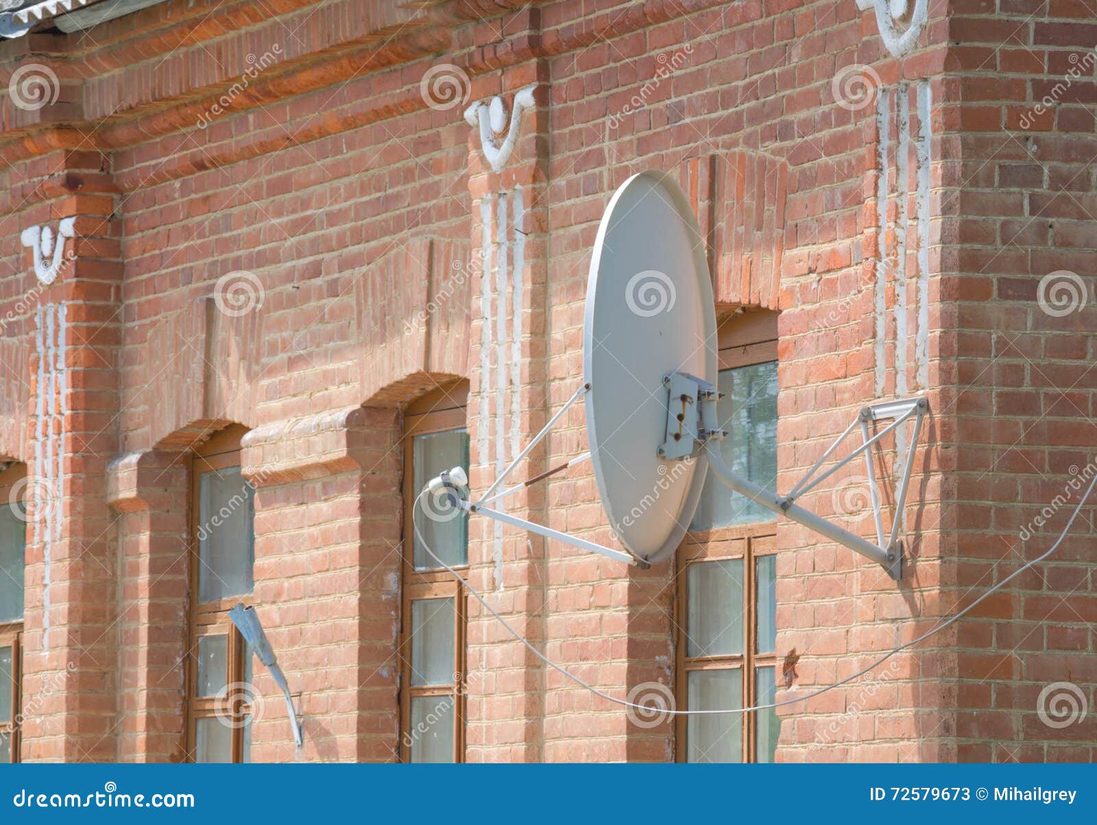 Satellite Dish on a Brick Wall. Stock Image Image of electronics