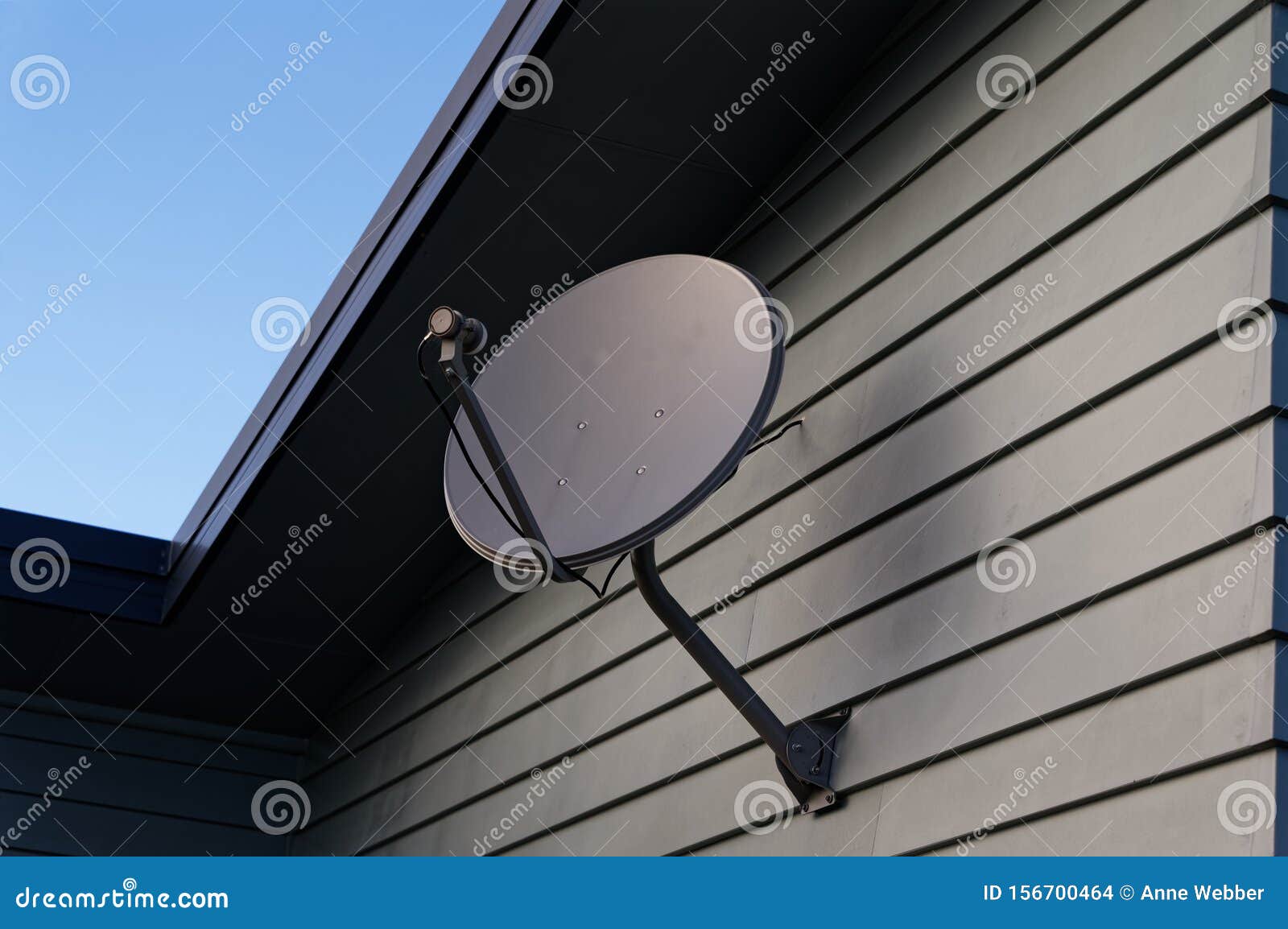 A Satellite Dish on the Side of a Building Stock Photo Image of
