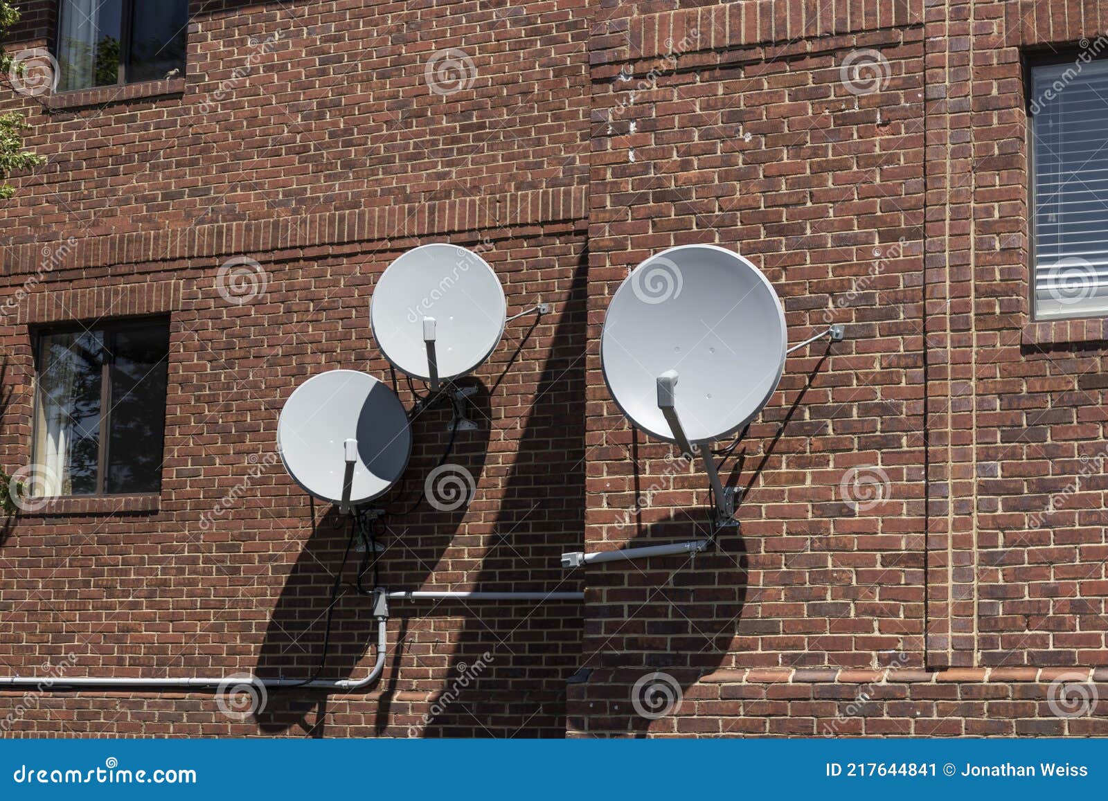 Satellite Dishes in Various Sizes and Shapes Waiting for Television
