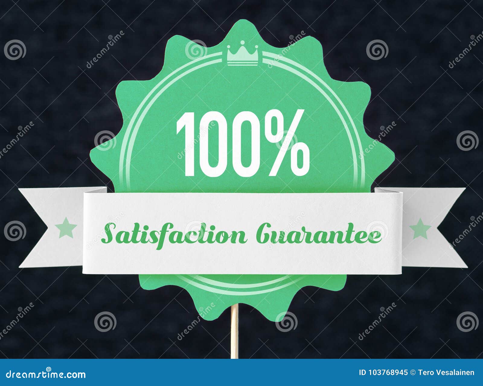 100% satisfaction guarantee badge cut from cardboard