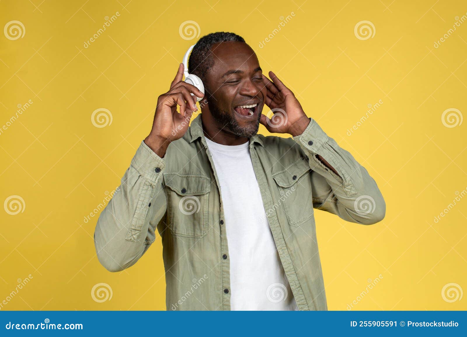 Satisfied Mature Black Man In Casual With Wireless Headphones With Closed Eyes Enjoy Music
