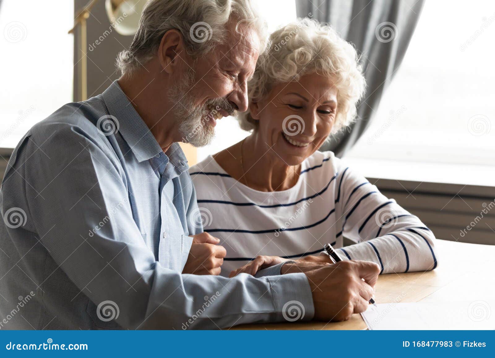 satisfied senior couple signing agreement buying medical health insurance