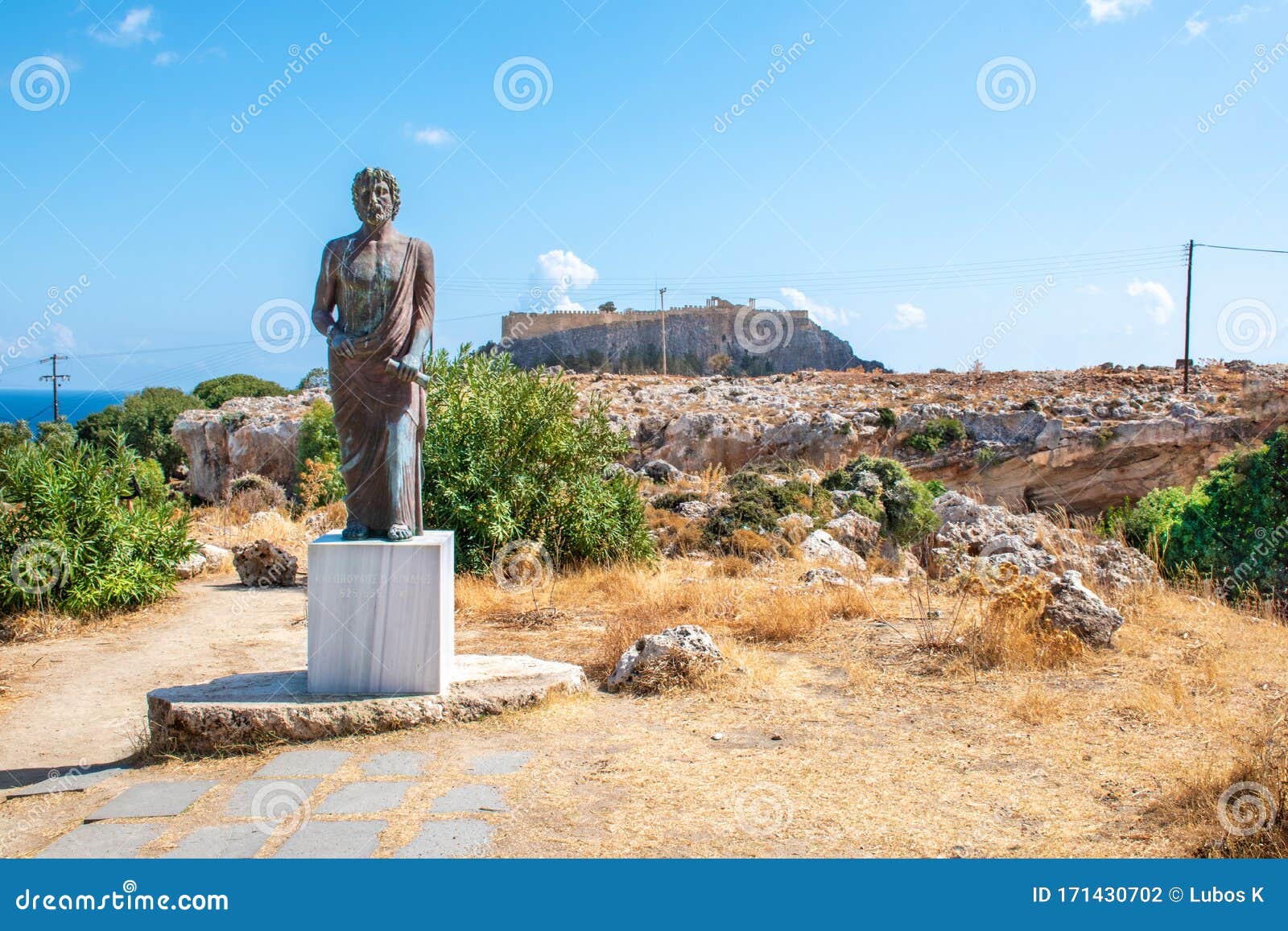 satue of cleobulus,  acropolis of lindos in background rhodes, greece