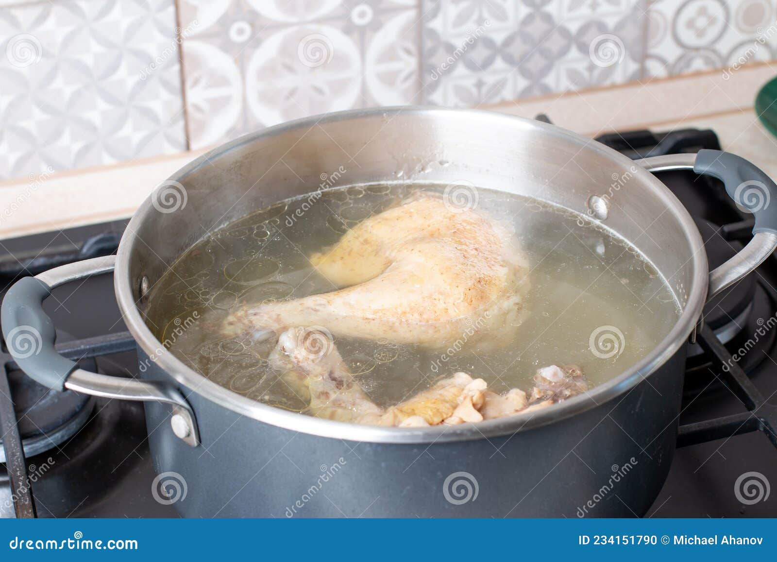 Saucepan with Bouillon on the Stove. Chicken Bouillon Stock Photo