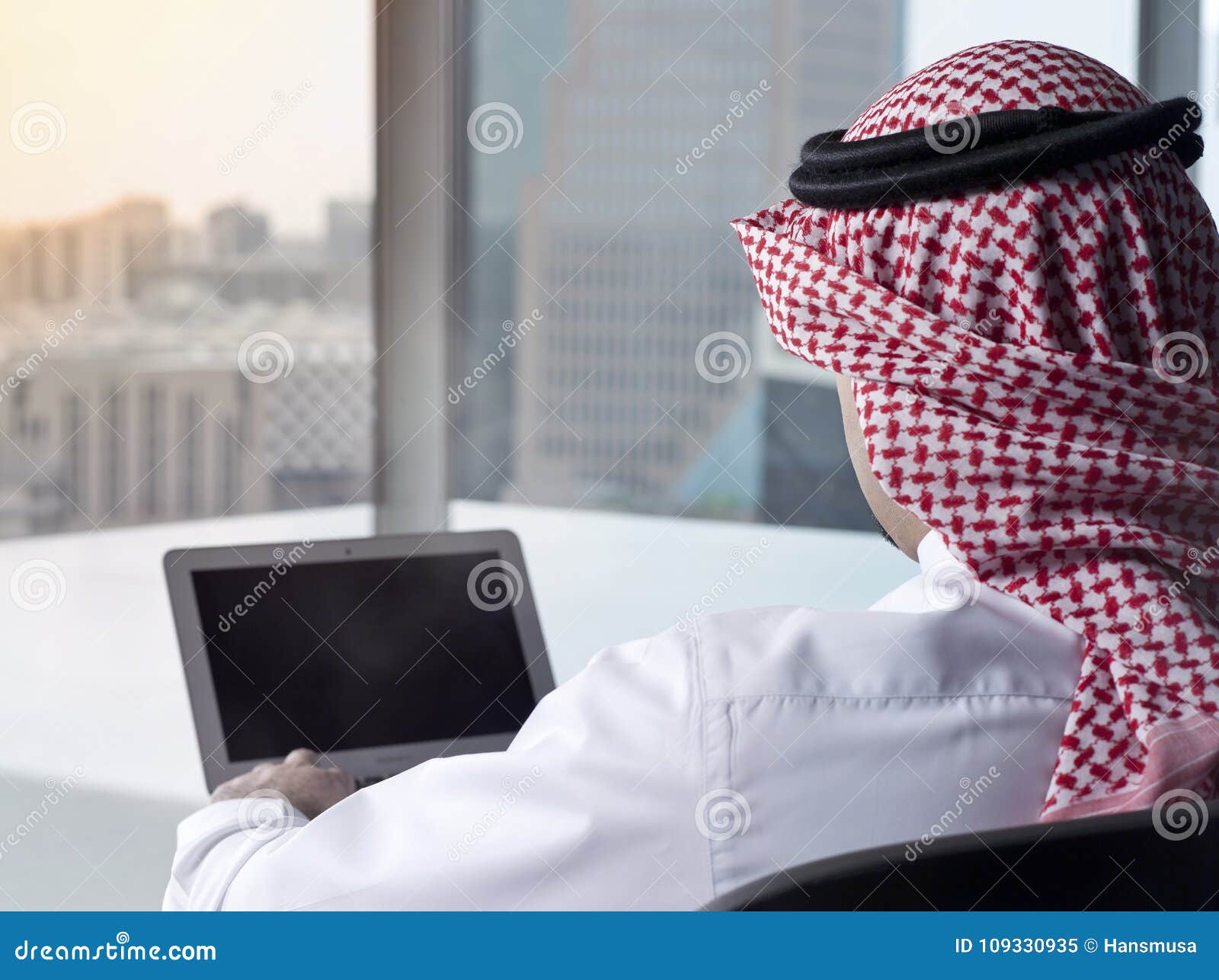 Saudi Arab Man Watching Laptop at Work Contemplating Stock Image