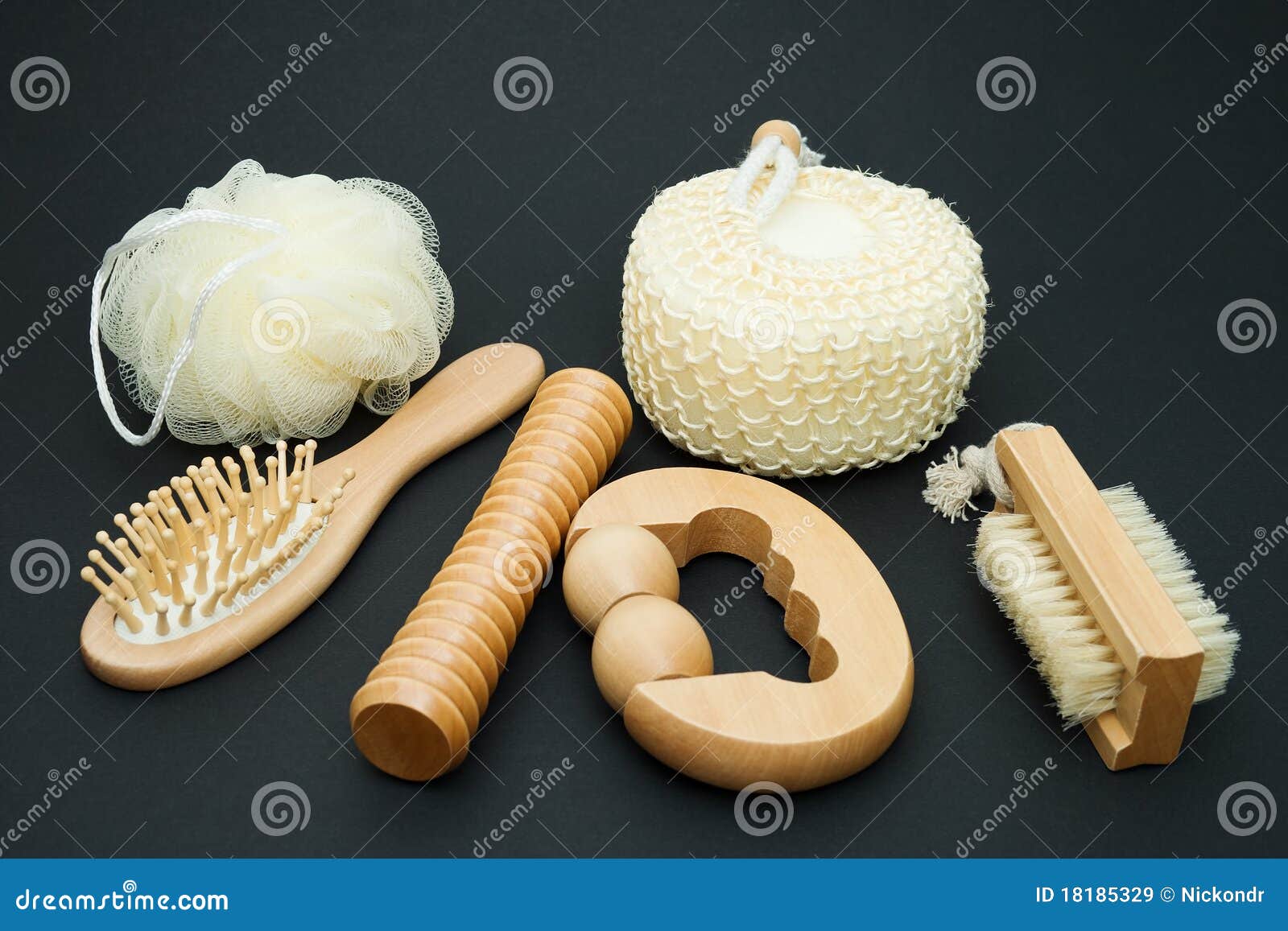 Sauna Set. Bath set - massage brush with wooden studs, massage roller, sponge, loofah, nylon tuff on a dark background.