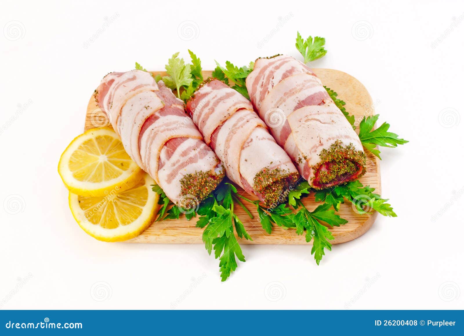 Sausage in beacon. Sausages in beacon with fresh parsley &amp; lemon on the woody board isolated