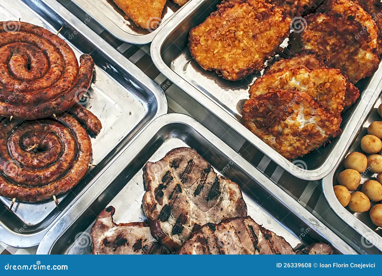 Sausage, ham, schnitzel and potatoes on plates exposed for consumption