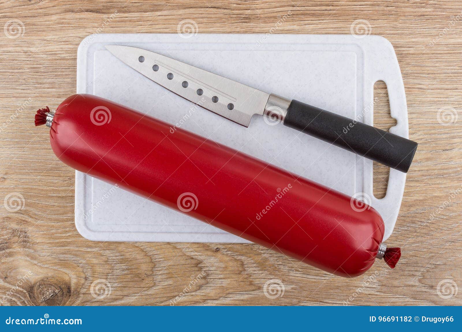Sausage in Shell and Kitchen Knife on Cutting Board Stock Photo Image