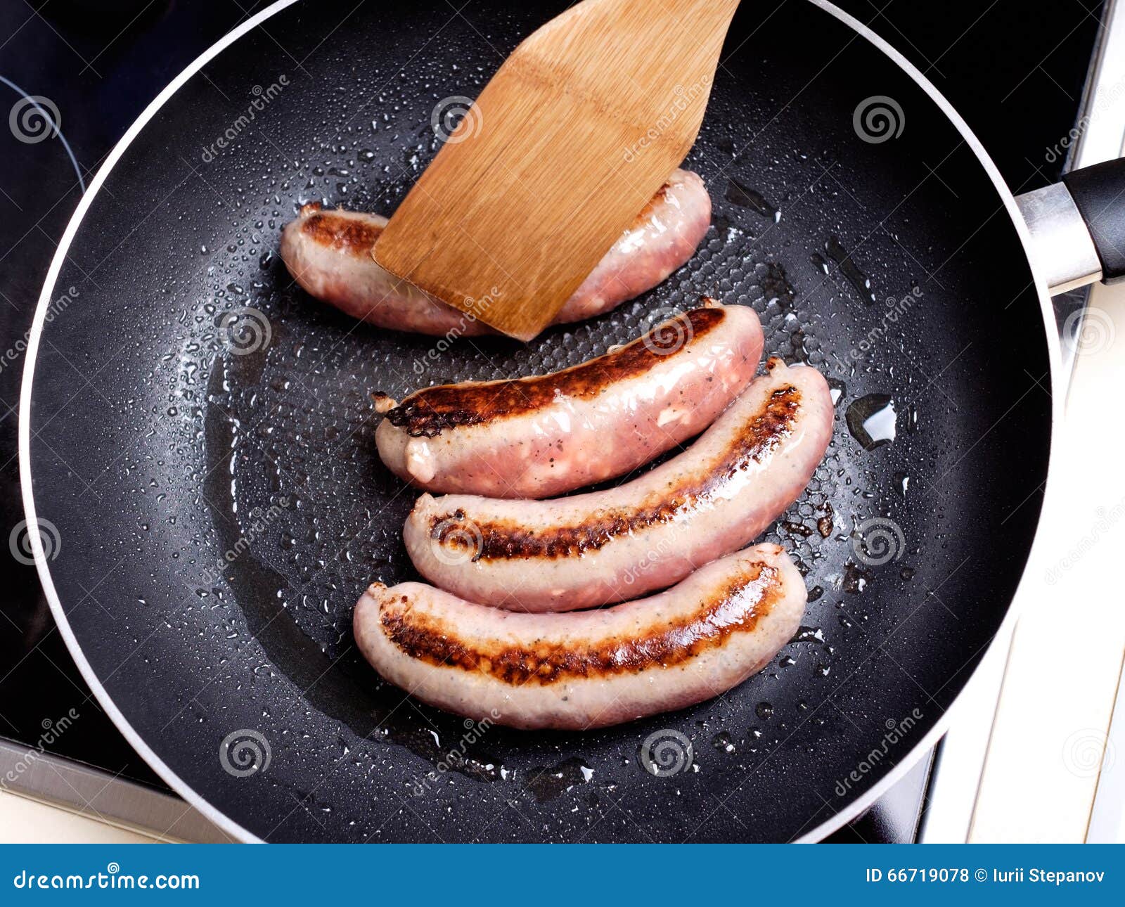 Sausages cooking stock photo. Image of spatter, nutritional 66719078