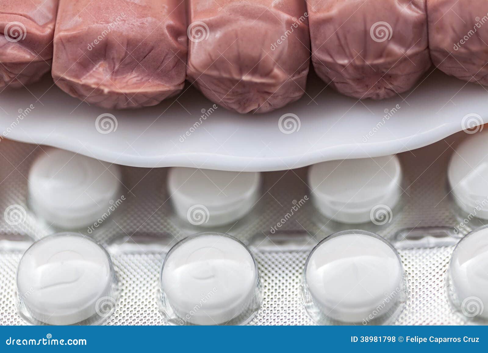 sausages on a plate along with diet pills