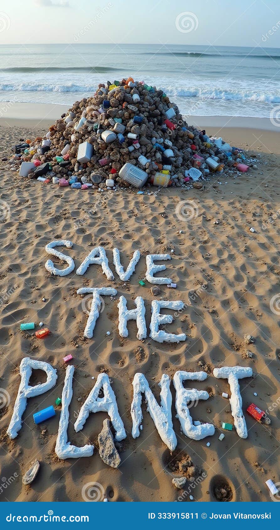 save the planet message on sandy beach with large pile of garbage