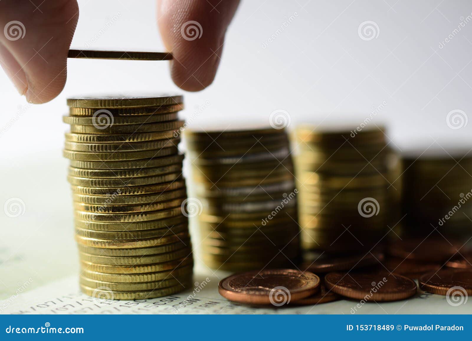 saving money concept preset by hand putting money coin stack