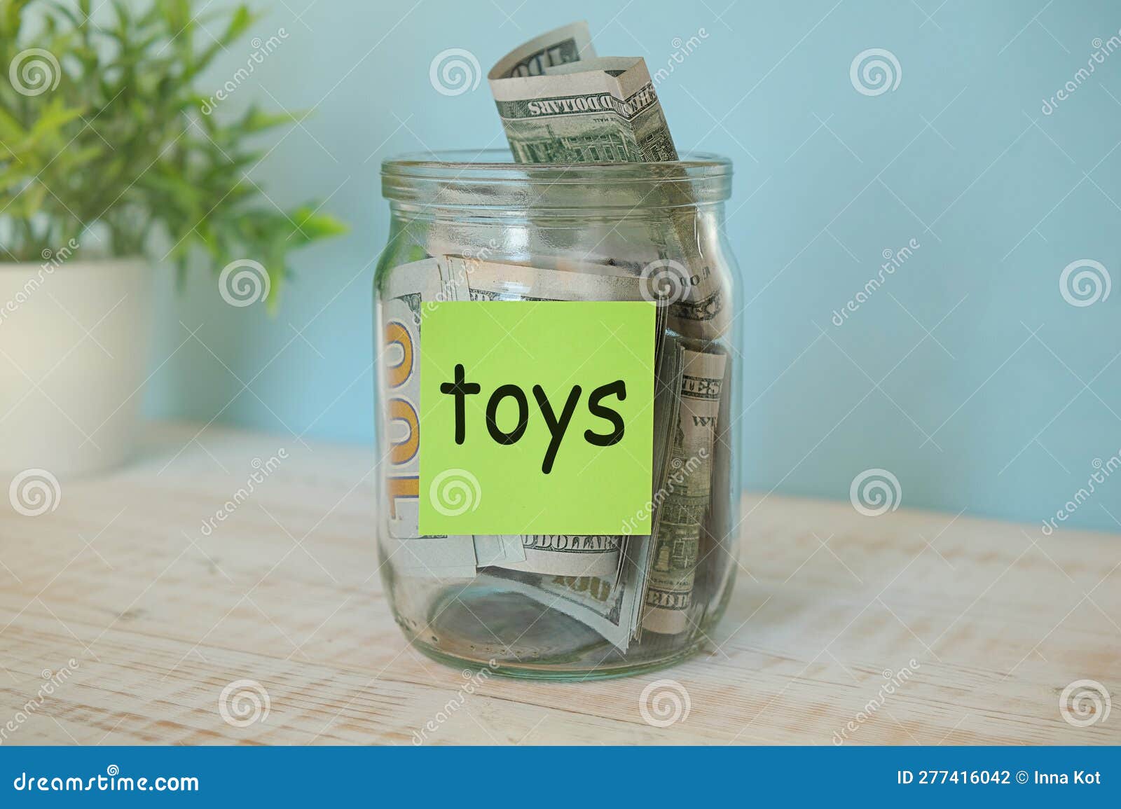 Saving Money for Toys Jar Concept. Money Box on Empty Table Collect