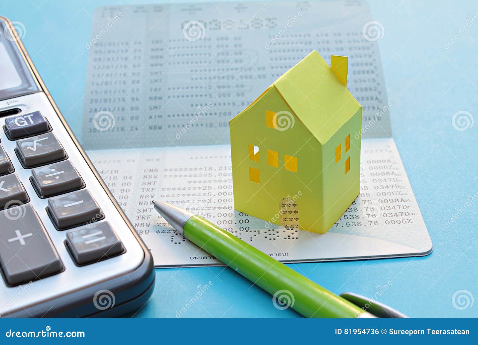 savings account passbook, calculator, pen and yellow paper house on blue background