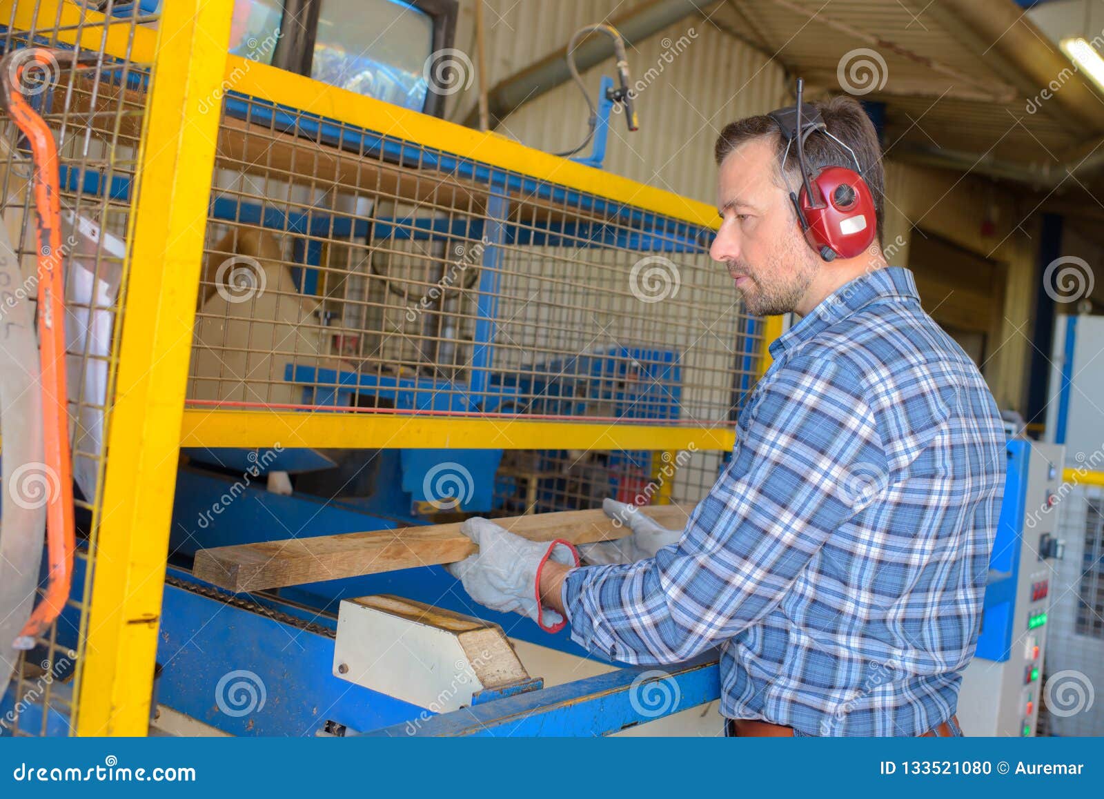 Sawmill Employee Working with Wood Tools and Machinery Stock Photo