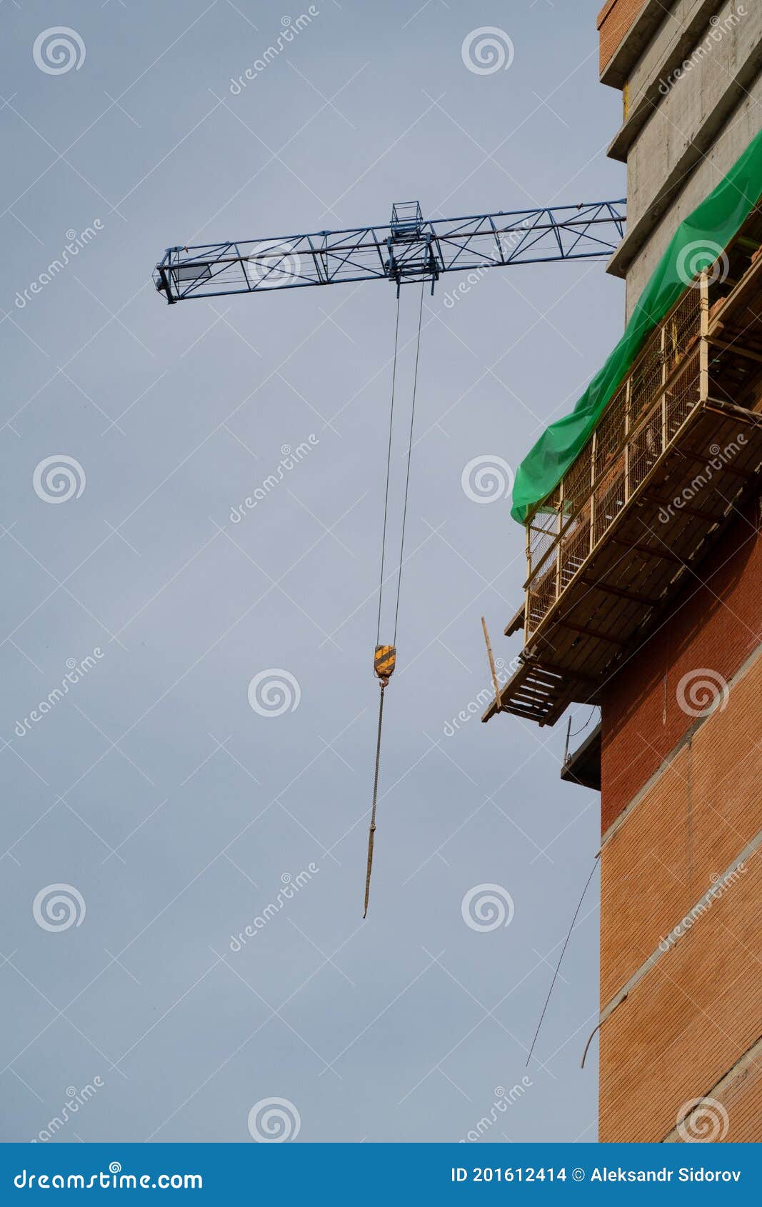 scaffolding on a high-rise building under construction and a crane boom