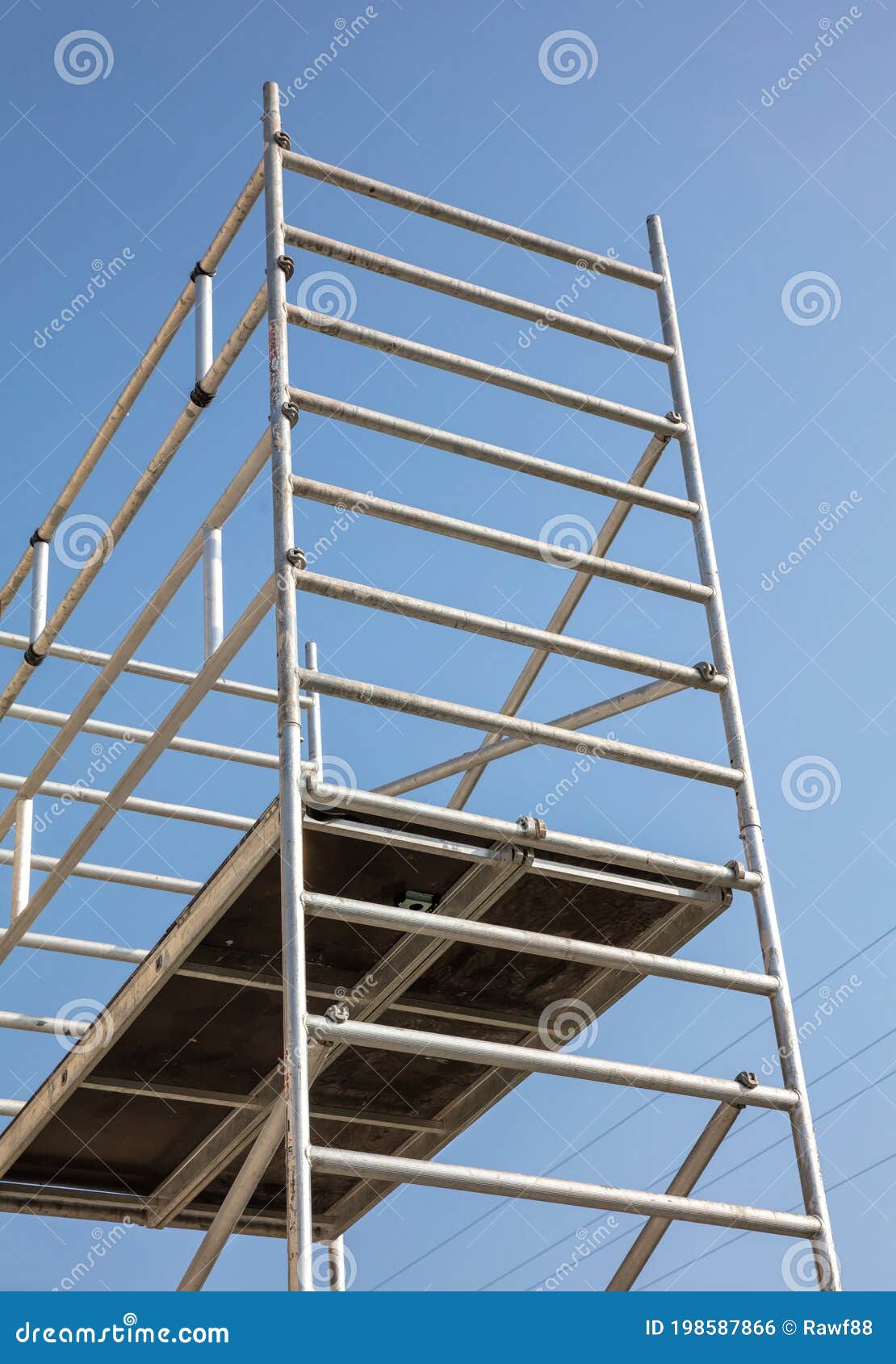 scaffolding, metal mobile scaffold aginst blue sky background