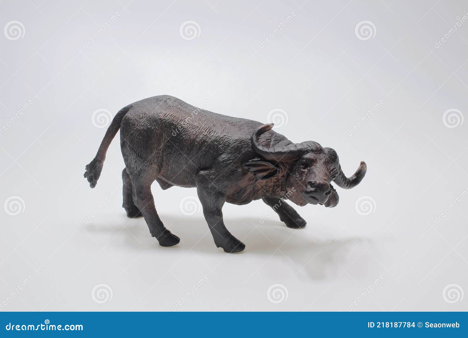Miniature Figure, Toy Bull Made from Plastic Isolate on a White Background Stock Photo Image