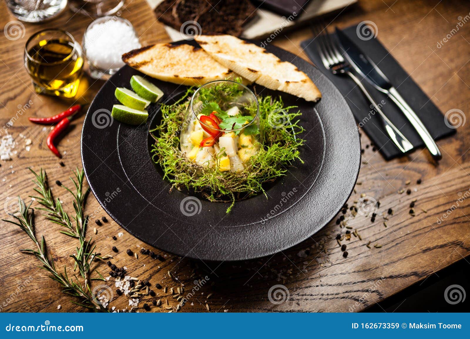 Scallop Ceviche Served in Black Bowl with Liquid Ice Smoke Stock Image ...