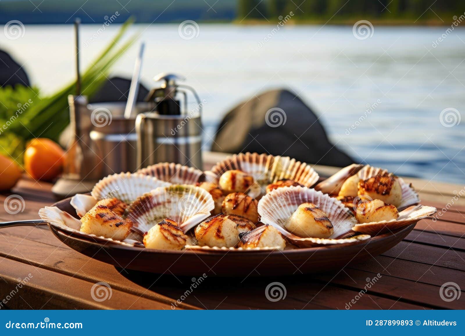Scallops in a Seashell Serving Dish beside Beach Bbq Stock Image