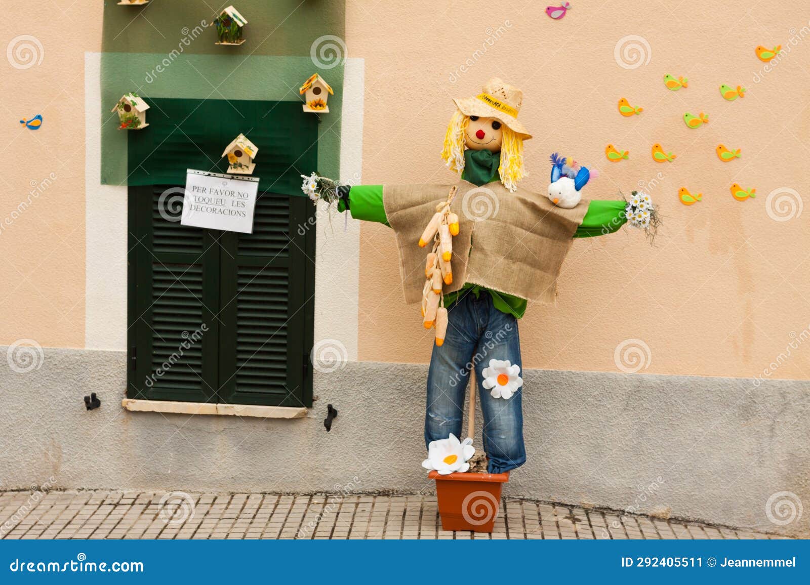scarecrow, decorated with flowers, birds and birdhouses, on costitx en flor