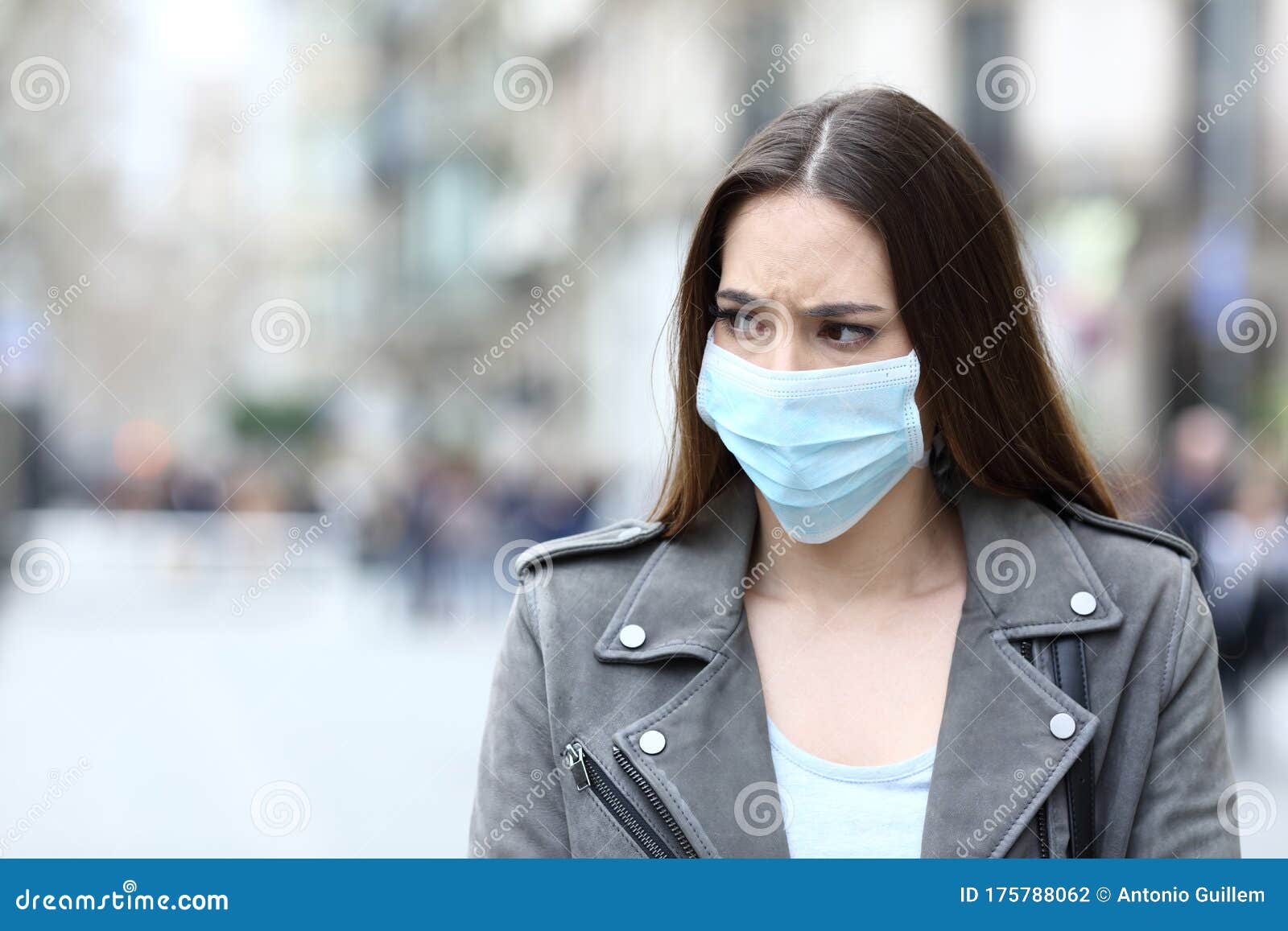 scared woman with protective mask avoiding contagion on street