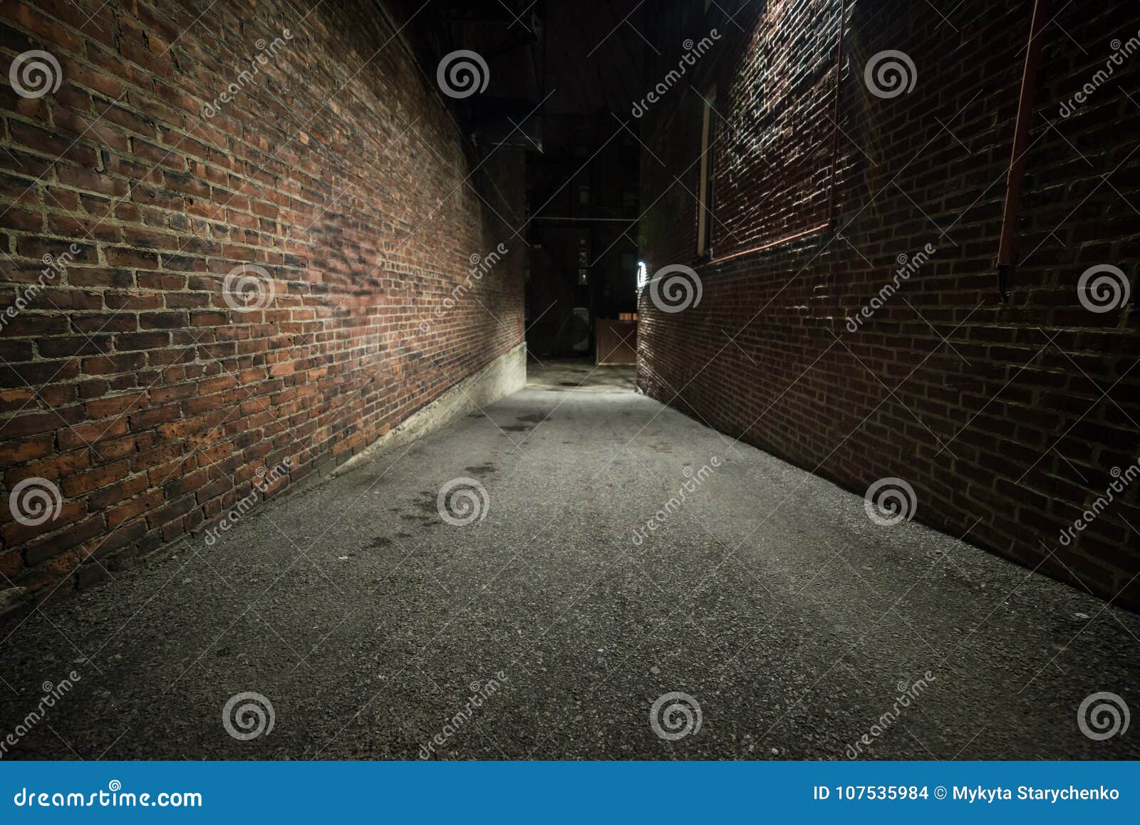 scary empty dark alley with brick walls.